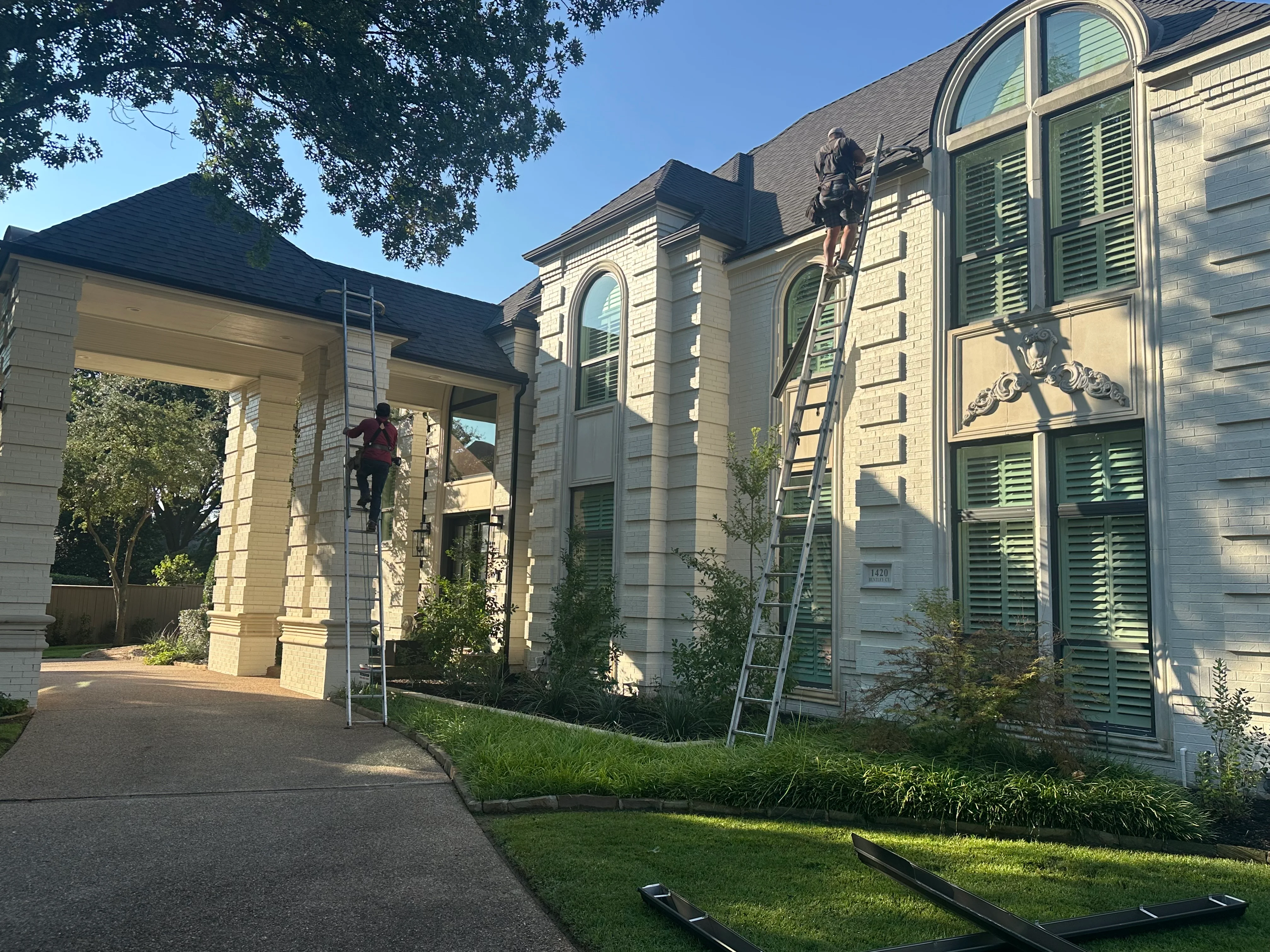 Dark architectural shingles installed on two-story home with multiple roof planes and dormers