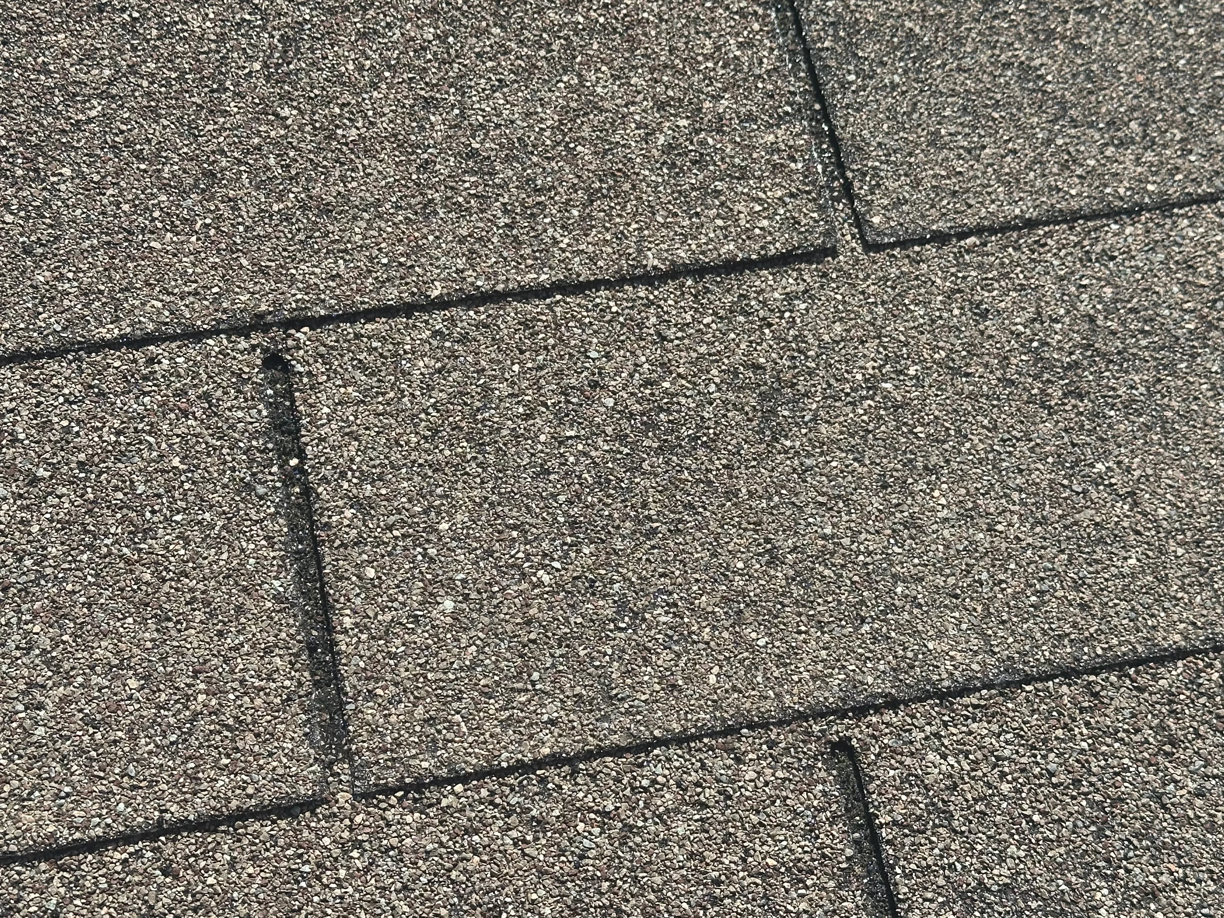 Asphalt shingles with black roof flashing and fasteners installed