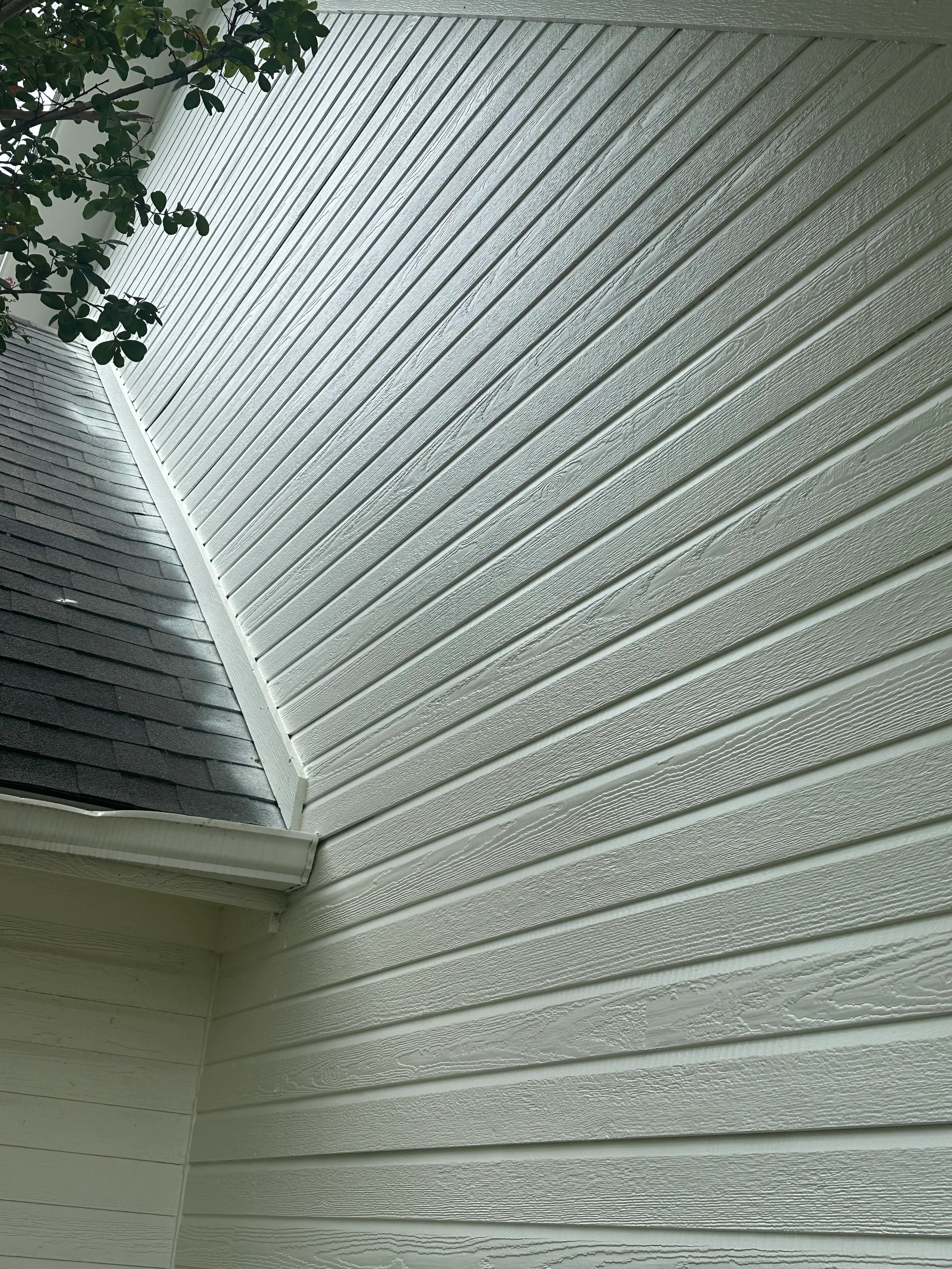 White fiber cement soffit and fascia boards installed along roofline with proper ventilation and trim