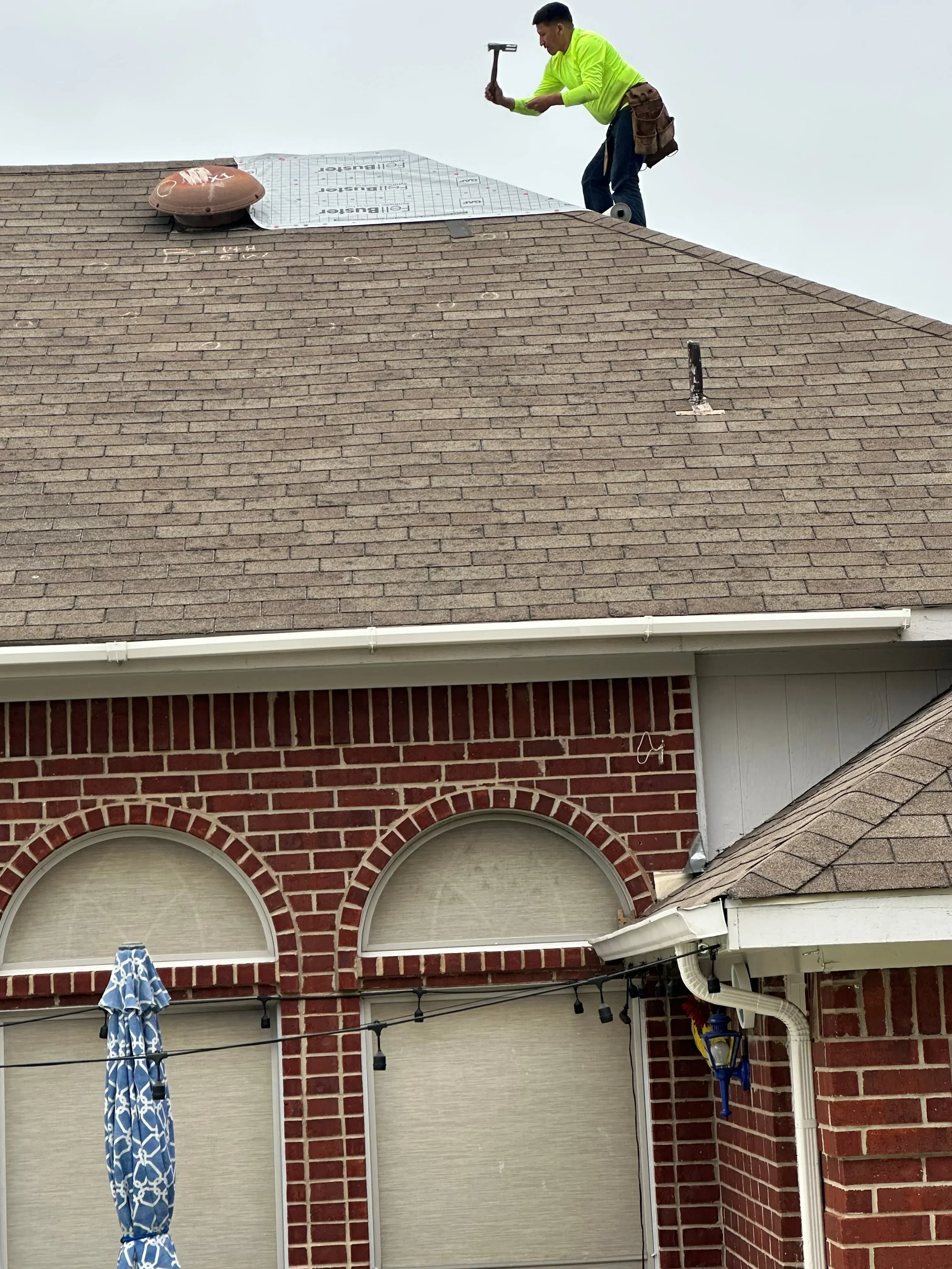 Brick chimney with arched details and metal flashing on residential roof