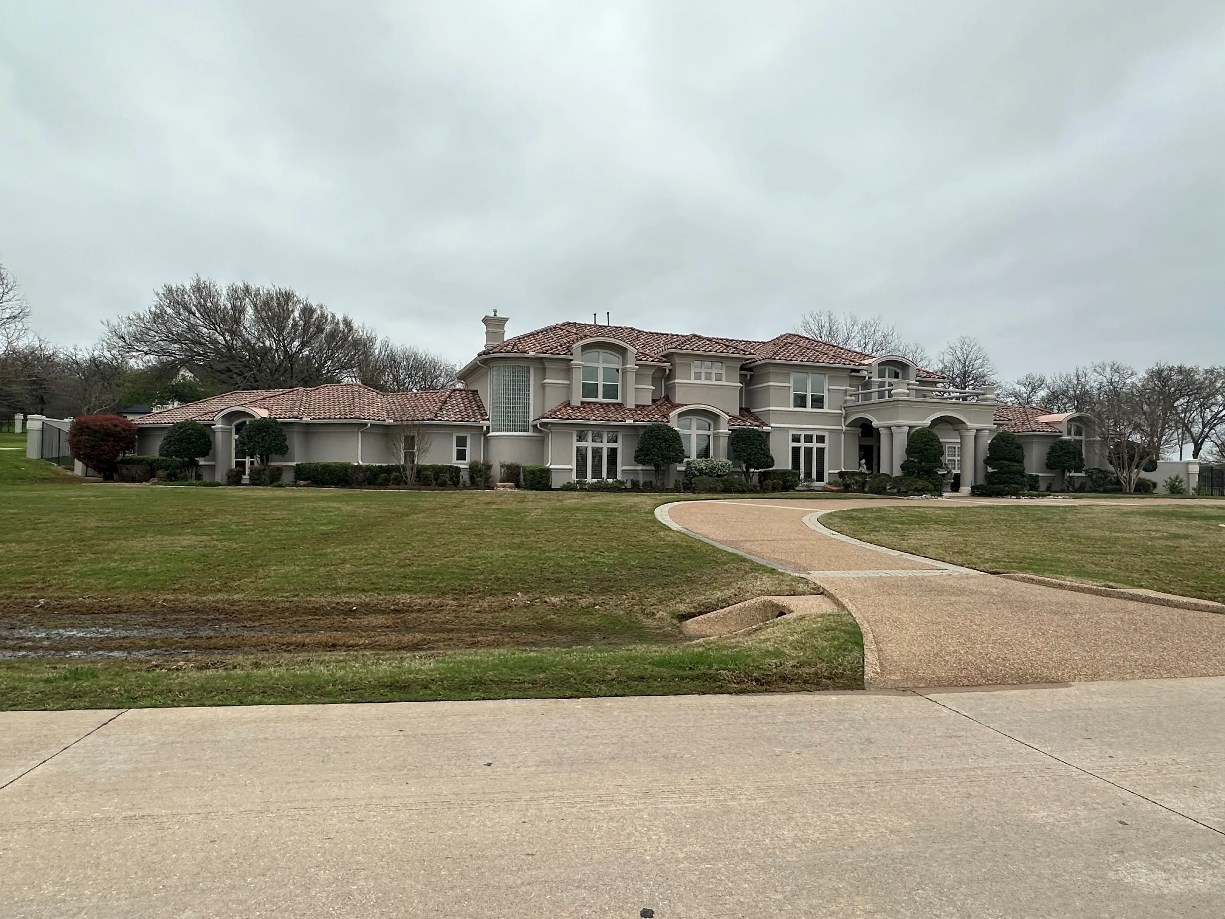 Clay tile roof on Mediterranean-style home with multiple peaks and curved architectural details
